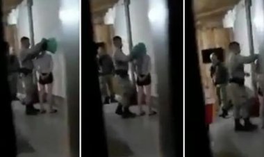 Policial militar coloca sacola na cabeça de mulher durante abordagem